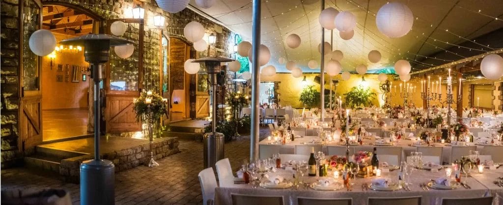 A wedding reception setup in The Piazza at The Gallery Wedding Venue with Chinese lanterns hanging from the roof.