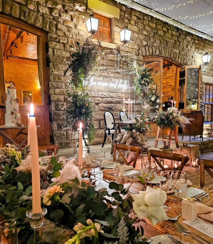 A wedding reception set up in a stone barn.
